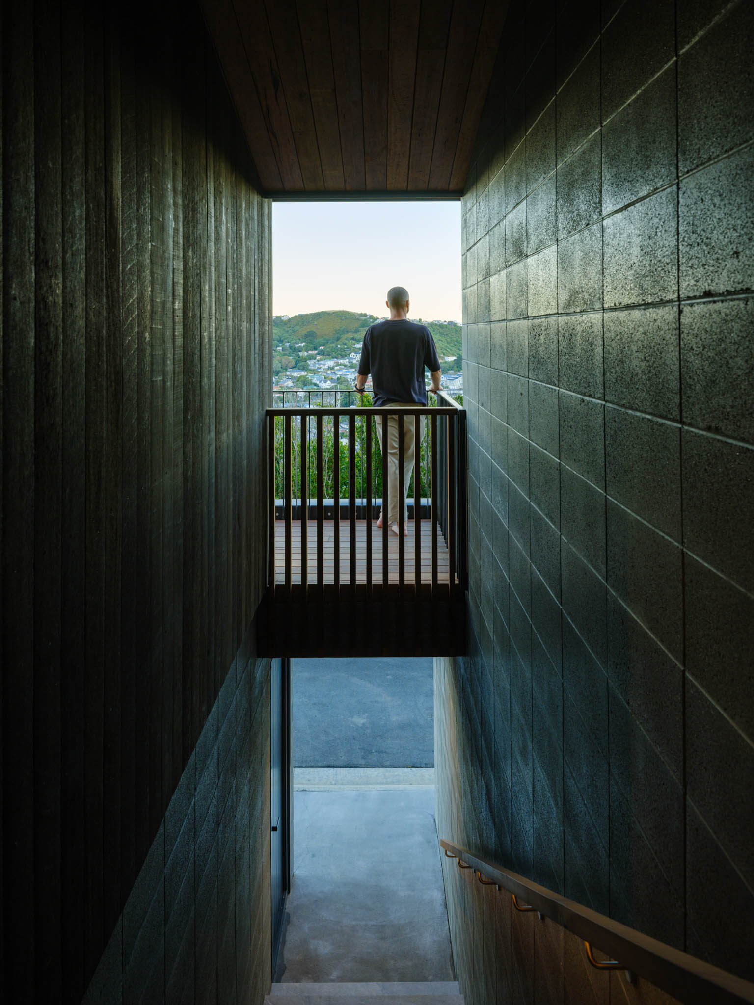 Man standing on deck of The Hill House, a bespoke home in Wellington.jpg