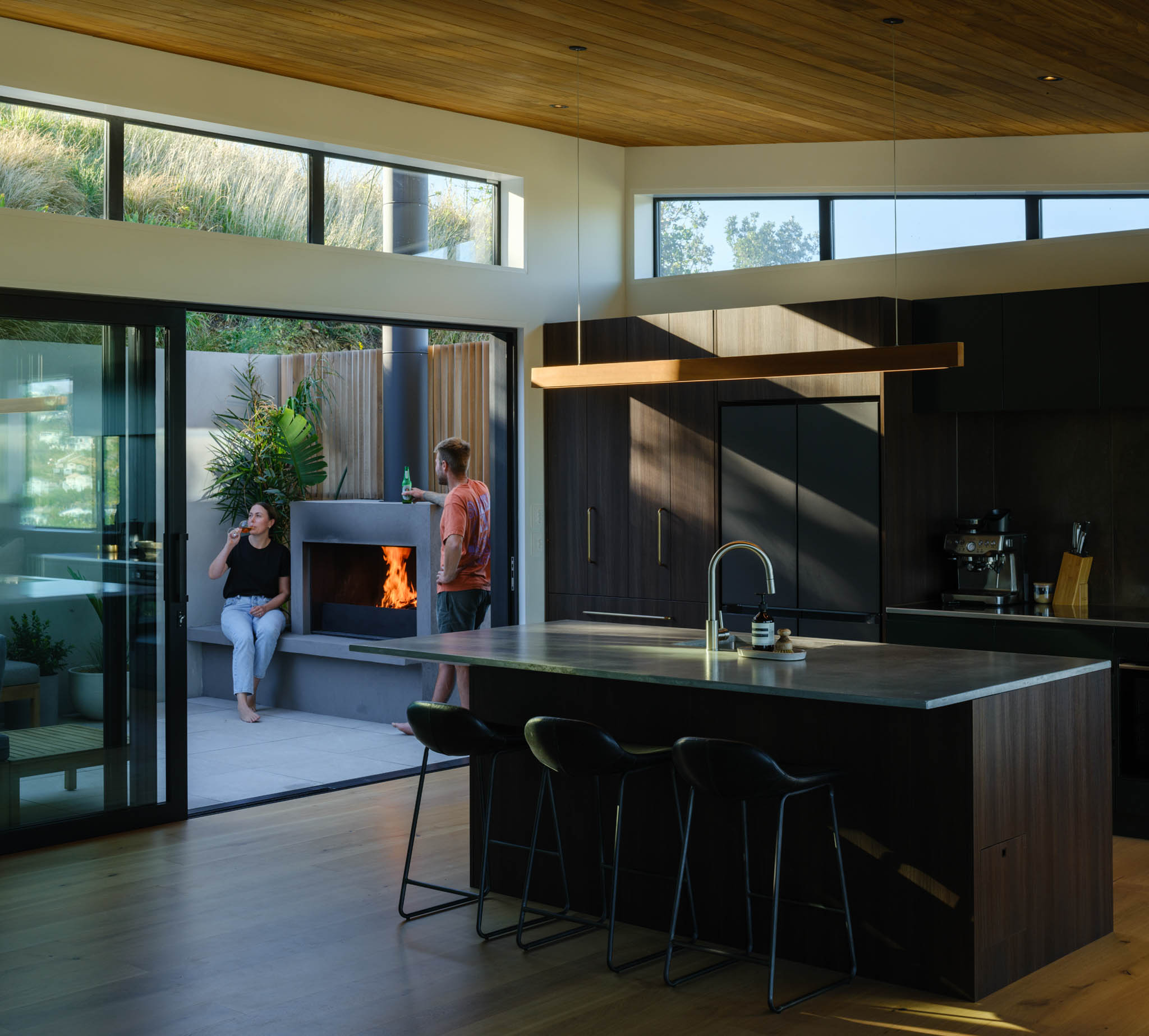 Couple enjoying their beautiful kitchen with large windows and sliding door to patio.jpg
